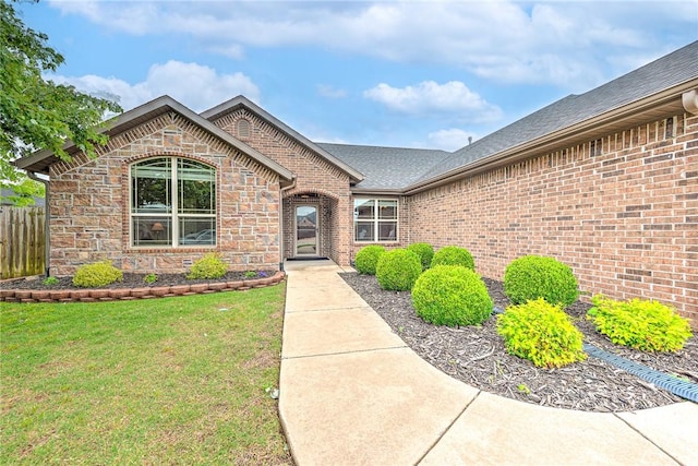 1805 SW Birch St, Bentonville, AR 72713 - view of exterior entry featuring brick siding and roof with shingles
