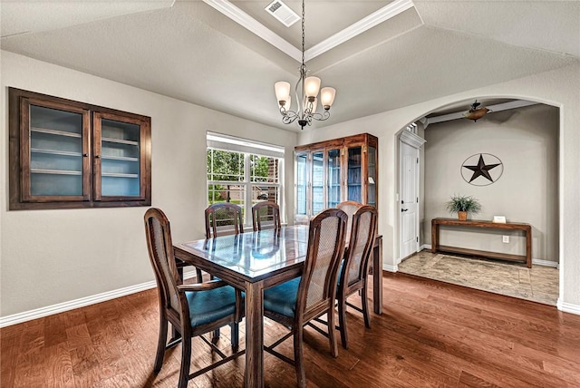 1805 SW Birch St, Bentonville, AR 72713 - dining space with arched walkways, dark wood-style floors, baseboards, a chandelier, and crown molding