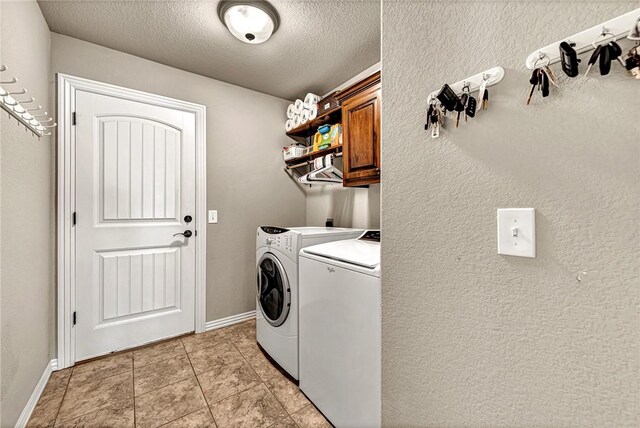 1805 SW Birch St, Bentonville, AR 72713 - washroom featuring cabinet space, separate washer and dryer, a textured ceiling, light tile patterned floors, and baseboards