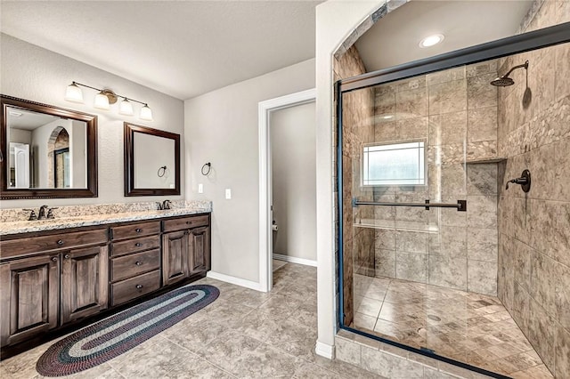 1805 SW Birch St, Bentonville, AR 72713 - full bath with a stall shower, double vanity, tile patterned floors, and baseboards