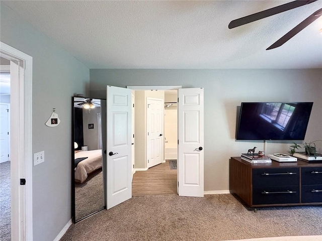 4408 W Apache Trl, Fayetteville, AR 72704 - bedroom with light carpet, a textured ceiling, baseboards, and ceiling fan