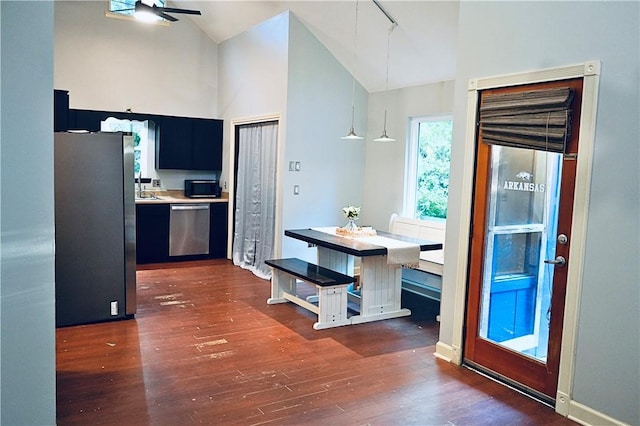 1211 N Mission Blvd, Fayetteville, AR 72701 - kitchen with appliances with stainless steel finishes, dark cabinetry, light countertops, high vaulted ceiling, and dark wood finished floors