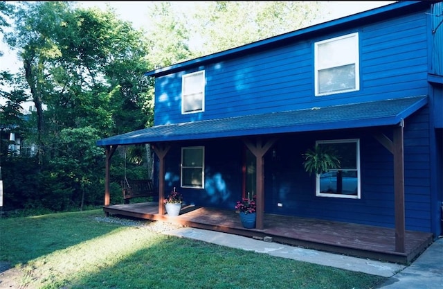 1211 N Mission Blvd, Fayetteville, AR 72701 - back of property with a yard, a shingled roof, and a deck