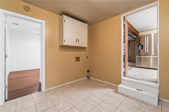 12549 Little Elm Rd, Farmington, AR 72730 - laundry room with hookup for a washing machine, cabinet space, baseboards, light tile patterned flooring, and electric dryer hookup