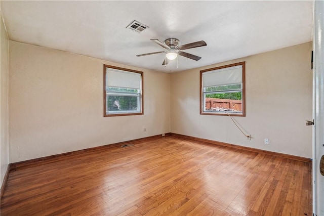 12549 Little Elm Rd, Farmington, AR 72730 - spare room featuring plenty of natural light, light wood finished floors, ceiling fan, and baseboards