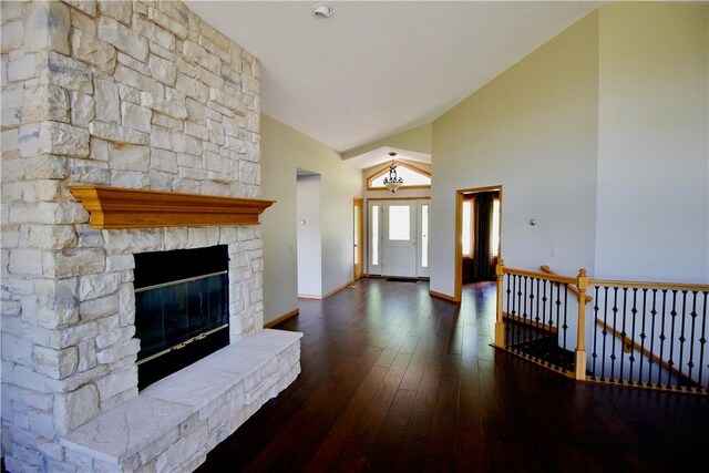 70 Shields Spur, Holiday Island, AR 72631 - unfurnished living room with wood-type flooring, baseboards, a fireplace, a chandelier, and high vaulted ceiling