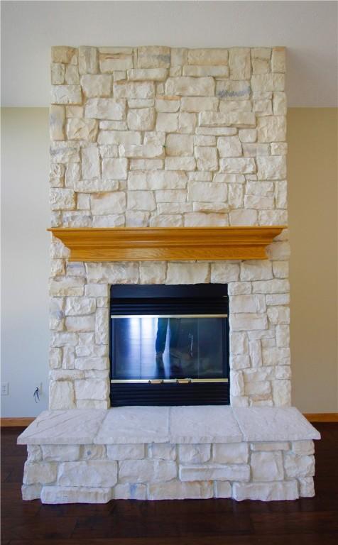 70 Shields Spur, Holiday Island, AR 72631 - detailed view of baseboards, a fireplace, and wood finished floors