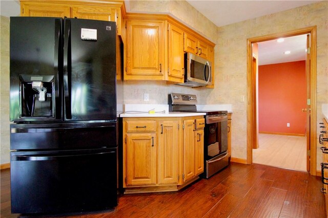 70 Shields Spur, Holiday Island, AR 72631 - kitchen with stainless steel appliances, dark wood-style floors, light countertops, and baseboards