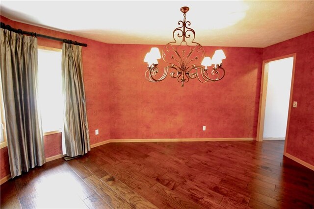 70 Shields Spur, Holiday Island, AR 72631 - unfurnished room with a chandelier, hardwood / wood-style floors, and baseboards