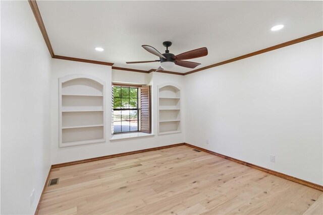 1640 N Boston Pl, Fayetteville, AR 72703 - empty room featuring crown molding, baseboards, wood finished floors, built in features, and recessed lighting