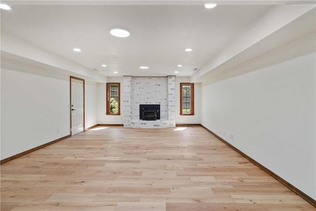 1640 N Boston Pl, Fayetteville, AR 72703 - unfurnished living room featuring baseboards, light wood-style flooring, recessed lighting, and a fireplace