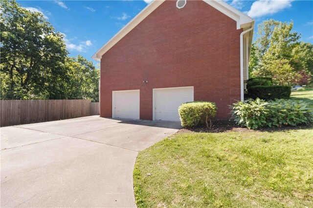1640 N Boston Pl, Fayetteville, AR 72703 - view of side of home with brick siding and concrete driveway