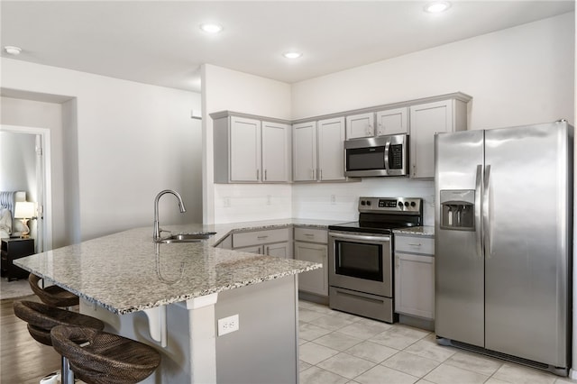 2405 Maplewood Ave, Lowell, AR 72745 - kitchen with stainless steel appliances, a peninsula, gray cabinets, a sink, and recessed lighting