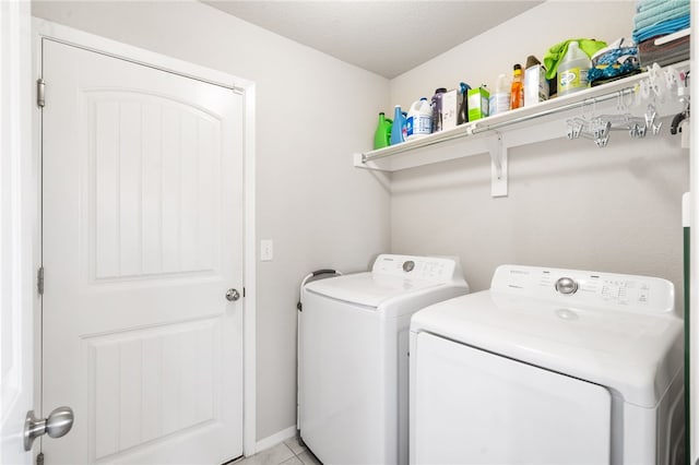 2405 Maplewood Ave, Lowell, AR 72745 - washroom with washer and clothes dryer and light tile patterned floors