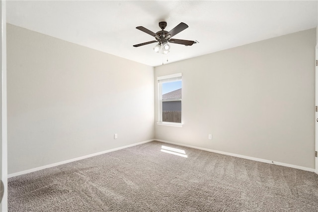 2405 Maplewood Ave, Lowell, AR 72745 - spare room featuring carpet flooring, a ceiling fan, and baseboards