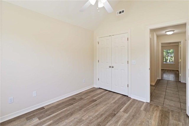 603 Highland Ct, Siloam Springs, AR 72761 - unfurnished bedroom with wood finished floors, a closet, baseboards, ceiling fan, and high vaulted ceiling