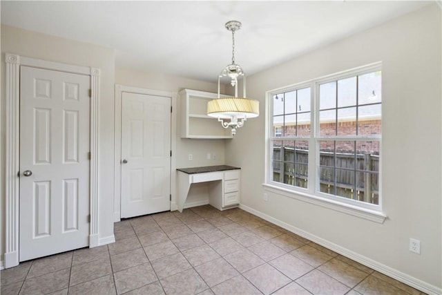 603 Highland Ct, Siloam Springs, AR 72761 - unfurnished dining area with baseboards, light tile patterned floors, and a desk
