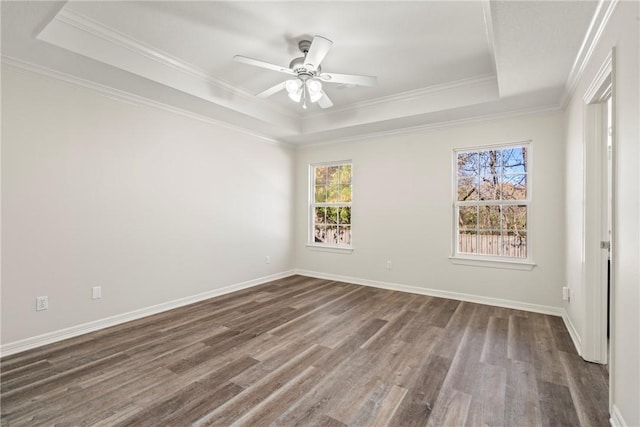 603 Highland Ct, Siloam Springs, AR 72761 - empty room with a tray ceiling, dark wood-type flooring, ornamental molding, a ceiling fan, and baseboards