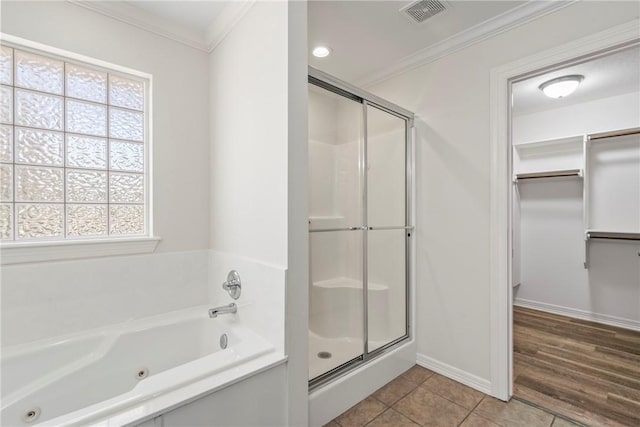 603 Highland Ct, Siloam Springs, AR 72761 - full bath with a stall shower, ornamental molding, a jetted tub, plenty of natural light, and tile patterned floors