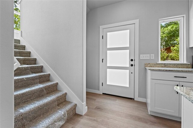 2 Brightling Ln, Bella Vista, AR 72715 - entryway featuring stairs, light wood-type flooring, and baseboards