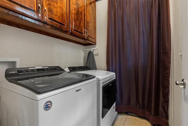 15100 Railroad Cut Rd, Rogers, AR 72756 - laundry room featuring independent washer and dryer, light tile patterned floors, and cabinet space