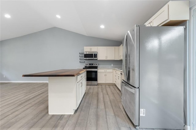 140 W Cardinal Ln, Diamond City, AR 72644 - kitchen with appliances with stainless steel finishes, butcher block counters, light wood-type flooring, vaulted ceiling, and white cabinets