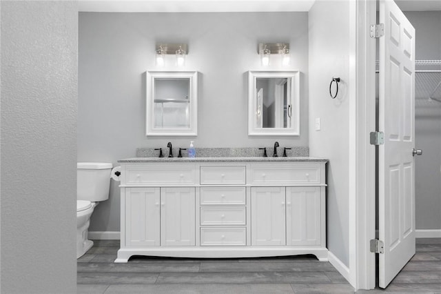 140 W Cardinal Ln, Diamond City, AR 72644 - bathroom with baseboards, toilet, and wood finished floors