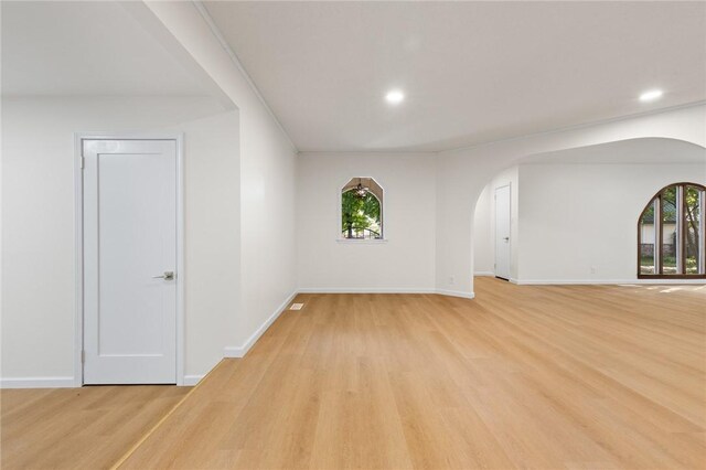 3916 O Street Ter, Harrison, AR 72601 - empty room featuring arched walkways, light wood-style flooring, plenty of natural light, and recessed lighting
