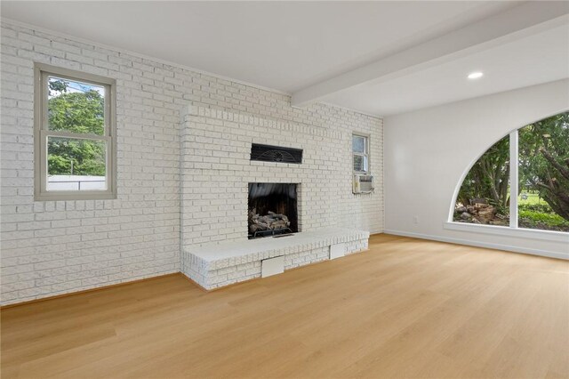3916 O Street Ter, Harrison, AR 72601 - unfurnished living room featuring wood finished floors, beam ceiling, a fireplace, baseboards, and brick wall