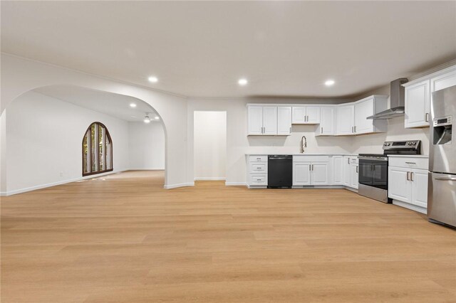 3916 O Street Ter, Harrison, AR 72601 - kitchen with stainless steel appliances, wall chimney range hood, arched walkways, white cabinets, and recessed lighting