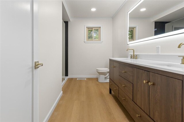 3916 O Street Ter, Harrison, AR 72601 - full bathroom with wood finished floors, toilet, baseboards, double vanity, and recessed lighting