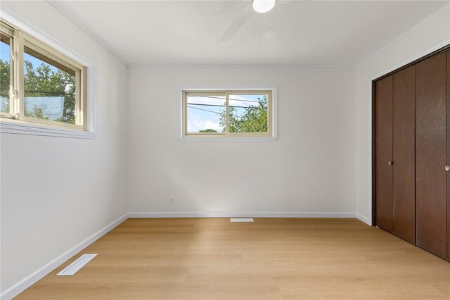 3916 O Street Ter, Harrison, AR 72601 - unfurnished bedroom featuring light wood finished floors, crown molding, a closet, and baseboards