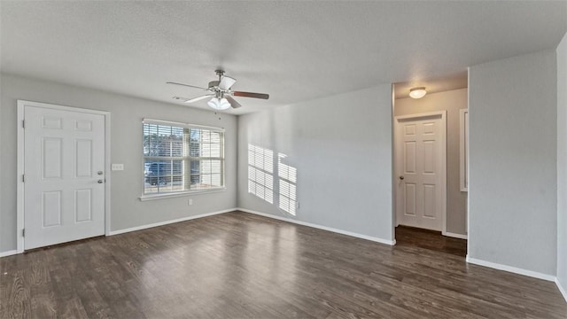 3357 Justice Dr, Springdale, AR 72764 - unfurnished living room with ceiling fan, dark wood finished floors, baseboards, and a textured ceiling