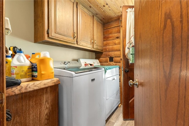 5287 Forgeson Rd, Harrison, AR 72601 - washroom featuring separate washer and dryer, cabinet space, and light wood-style floors