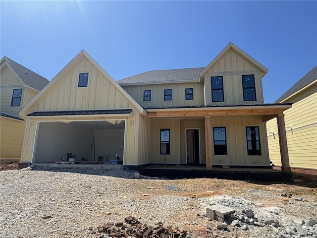 4112 Erin Dr, Rogers, AR 72758 - view of front of property featuring board and batten siding, a porch, a garage, and a standing seam roof