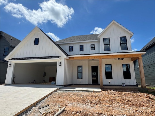 4112 Erin Dr, Rogers, AR 72758 - modern farmhouse featuring board and batten siding, a standing seam roof, driveway, a metal roof, and roof with shingles