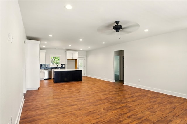 4551 Gibson St, Springdale, AR 72762 - unfurnished living room featuring dark wood-style flooring, recessed lighting, a ceiling fan, a sink, and baseboards