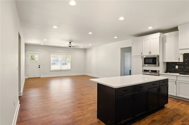 4551 Gibson St, Springdale, AR 72762 - kitchen featuring stainless steel appliances, white cabinetry, dark cabinets, a ceiling fan, and a center island