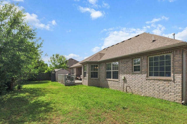 4007 W Song Bird Pl, Fayetteville, AR 72704 - rear view of property featuring a shingled roof, a wooden deck, and brick siding