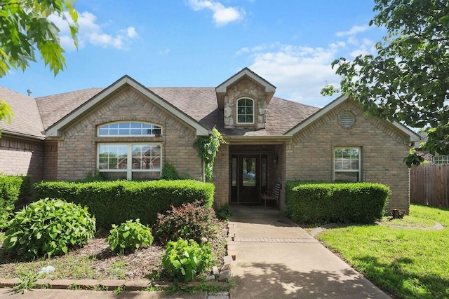 4007 W Song Bird Pl, Fayetteville, AR 72704 - view of front facade featuring brick siding, a shingled roof, and stone siding