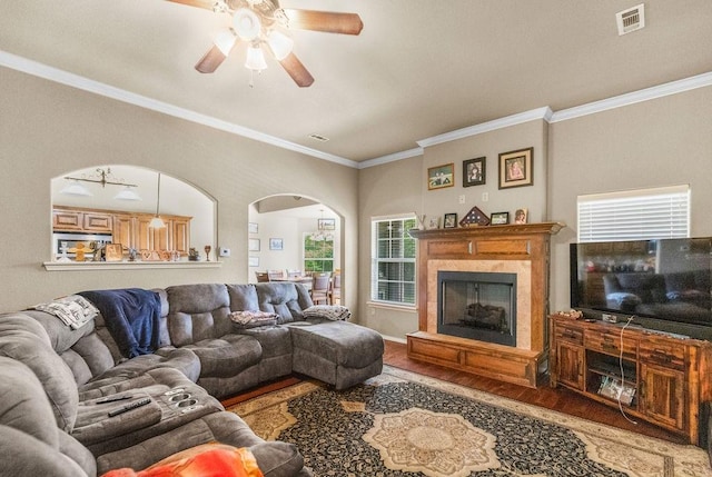 4007 W Song Bird Pl, Fayetteville, AR 72704 - living area with wood finished floors, arched walkways, crown molding, a ceiling fan, and a fireplace