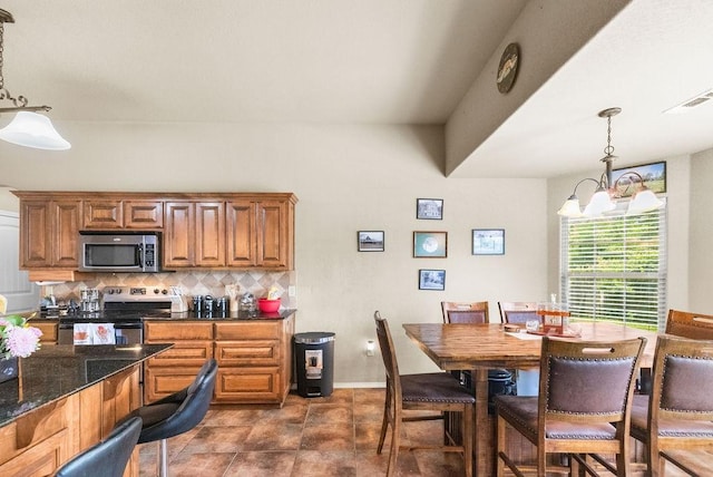 4007 W Song Bird Pl, Fayetteville, AR 72704 - kitchen with stainless steel appliances, decorative backsplash, decorative light fixtures, and brown cabinetry