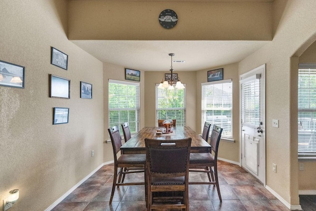 4007 W Song Bird Pl, Fayetteville, AR 72704 - dining area with baseboards, a chandelier, plenty of natural light, and dark stone finish flooring