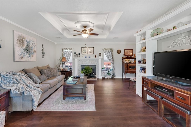 1480 Dallas St, Gravette, AR 72736 - living area featuring a raised ceiling, a ceiling fan, dark wood-style flooring, ornamental molding, and a fireplace