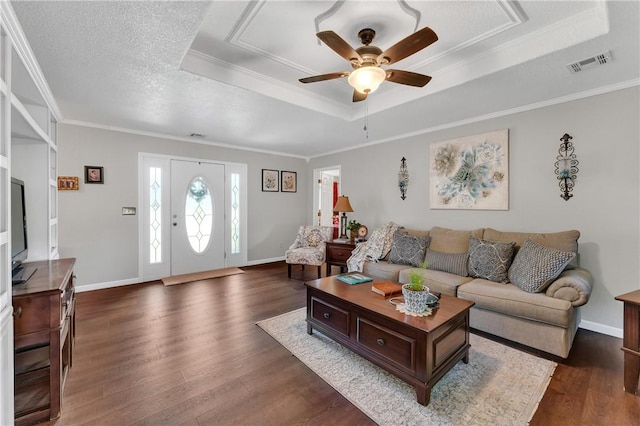 1480 Dallas St, Gravette, AR 72736 - living room featuring a raised ceiling, dark wood finished floors, a ceiling fan, ornamental molding, and baseboards