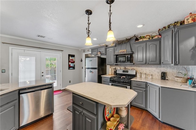 1480 Dallas St, Gravette, AR 72736 - kitchen featuring stainless steel appliances, gray cabinets, ornamental molding, tasteful backsplash, and light countertops