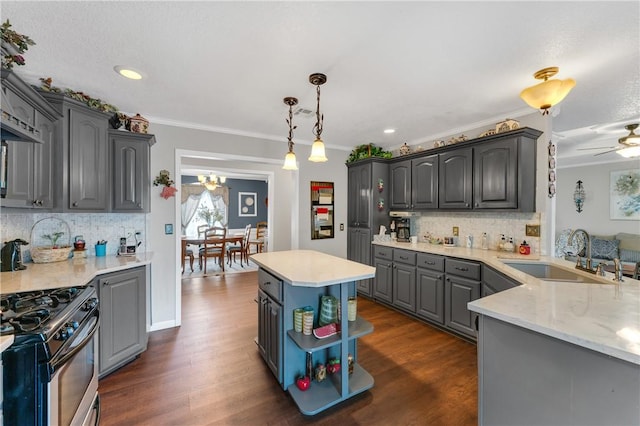 1480 Dallas St, Gravette, AR 72736 - kitchen featuring a sink, stainless steel gas range, decorative backsplash, crown molding, and dark wood finished floors