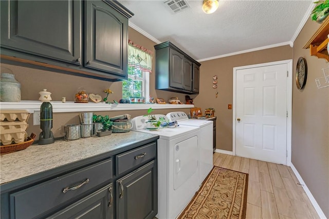 1480 Dallas St, Gravette, AR 72736 - laundry room featuring cabinet space, washing machine and dryer, ornamental molding, light wood-type flooring, and a textured ceiling