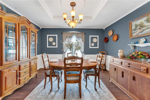 1480 Dallas St, Gravette, AR 72736 - dining room with a chandelier, a raised ceiling, a wainscoted wall, dark wood-type flooring, and crown molding