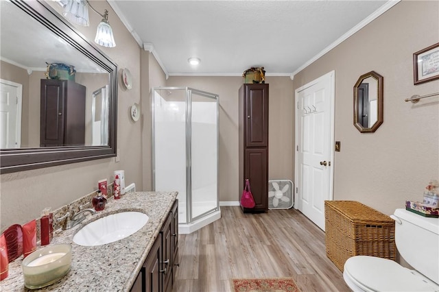 1480 Dallas St, Gravette, AR 72736 - bathroom with crown molding, a stall shower, wood finished floors, toilet, and vanity